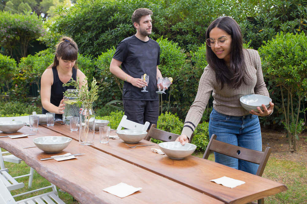 Three customers laying an outside table