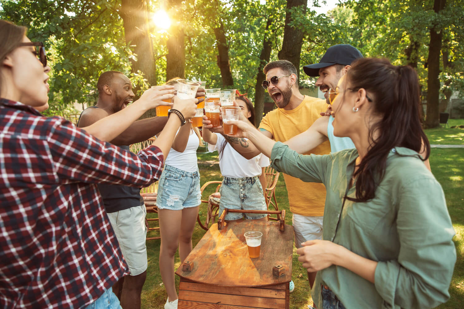 Friends toasting drinks together outside