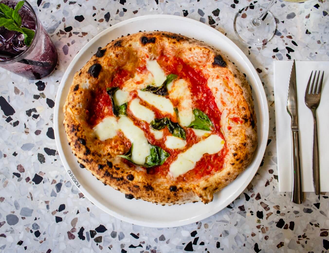 A pizza cooling on a wire rack