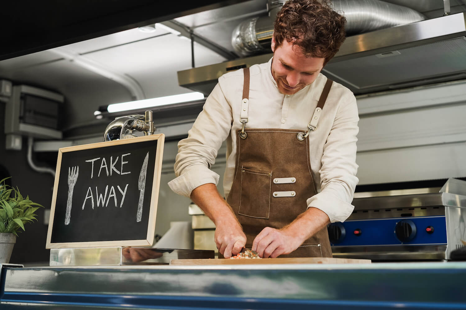 A chef preparing food in a food truck